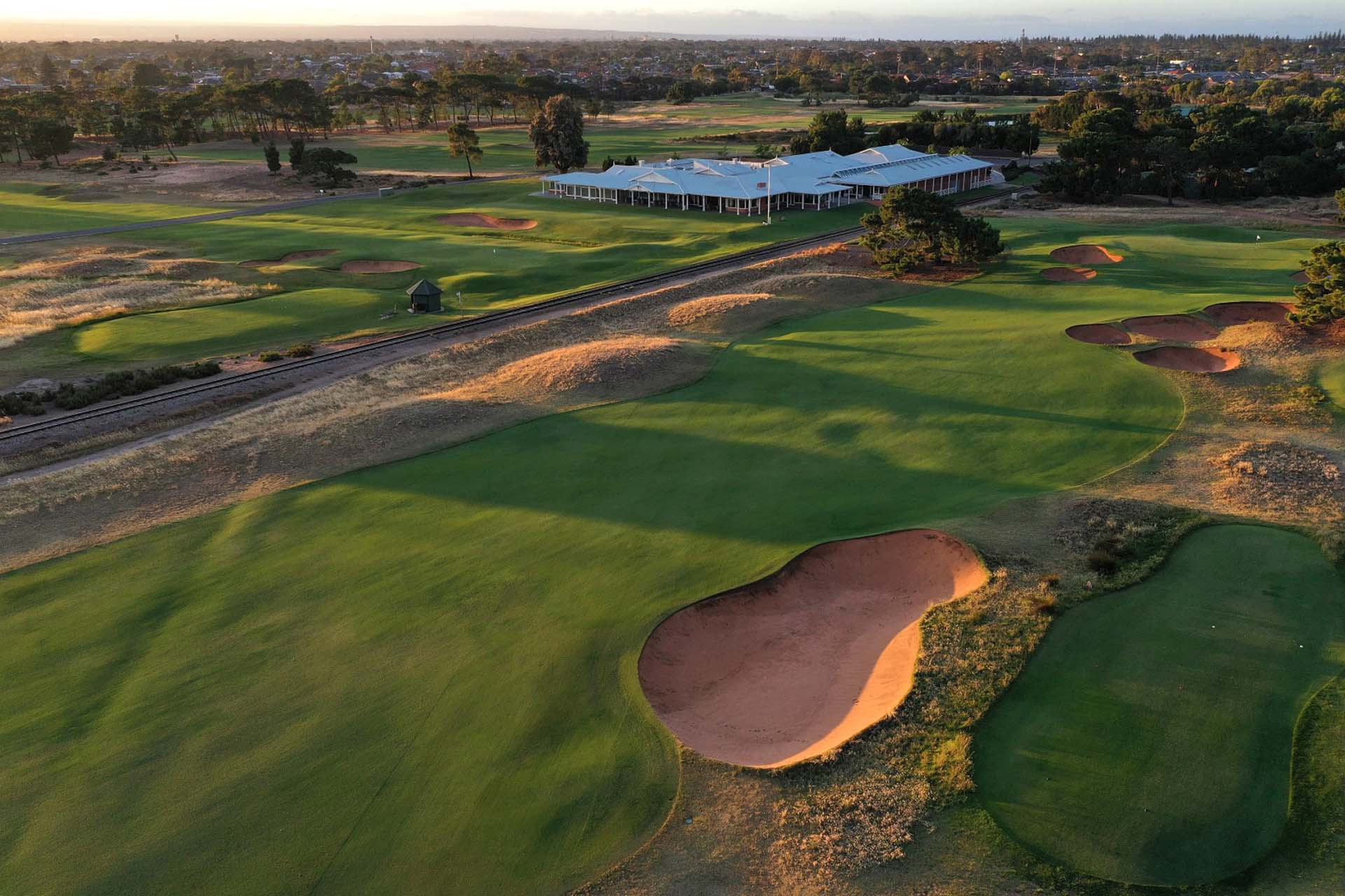 Royal Adelaide Golf Club - Par 5, 2nd Green, Railway Line & Clubhouse / Photo: Gary Lisbon Golf Photography